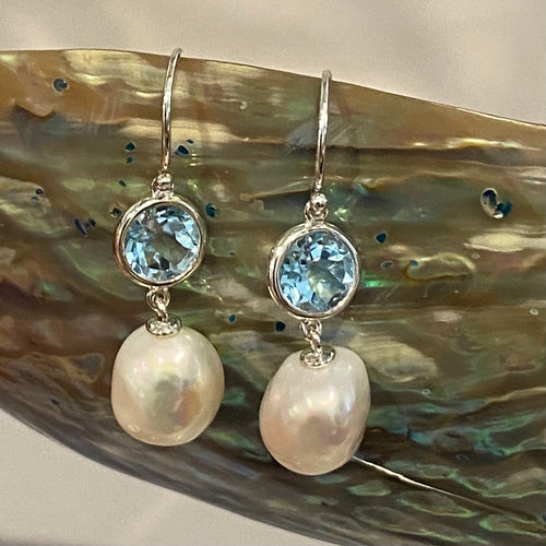 925 Sterling silver Hook style earrings, featuring  Baroque 11mm White Freshwater Pearls, suspended under a 9mm Bezel set Blue Topaz

Overall height 40mm